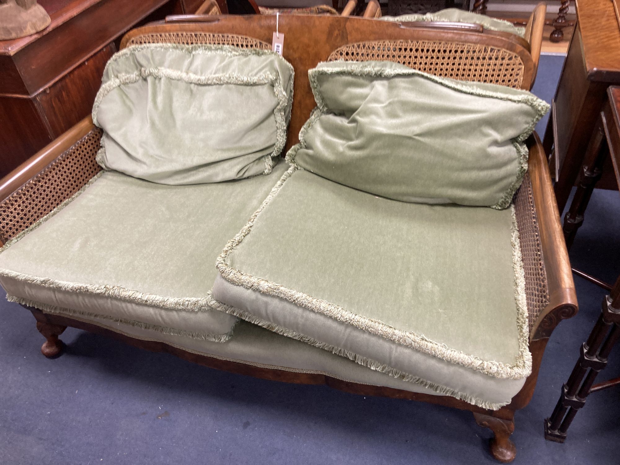 A 1920s mahogany framed three piece Bergere suite, together with a stool